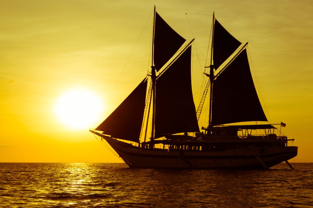 komodo travel ship during sunset
