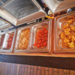 Hot buffet trays of grilled tomatoes and beans