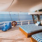 Blue-striped daybeds and a lifebuoy on the sun deck