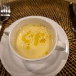 Cup of creamy soup finished with a drizzle of oil
