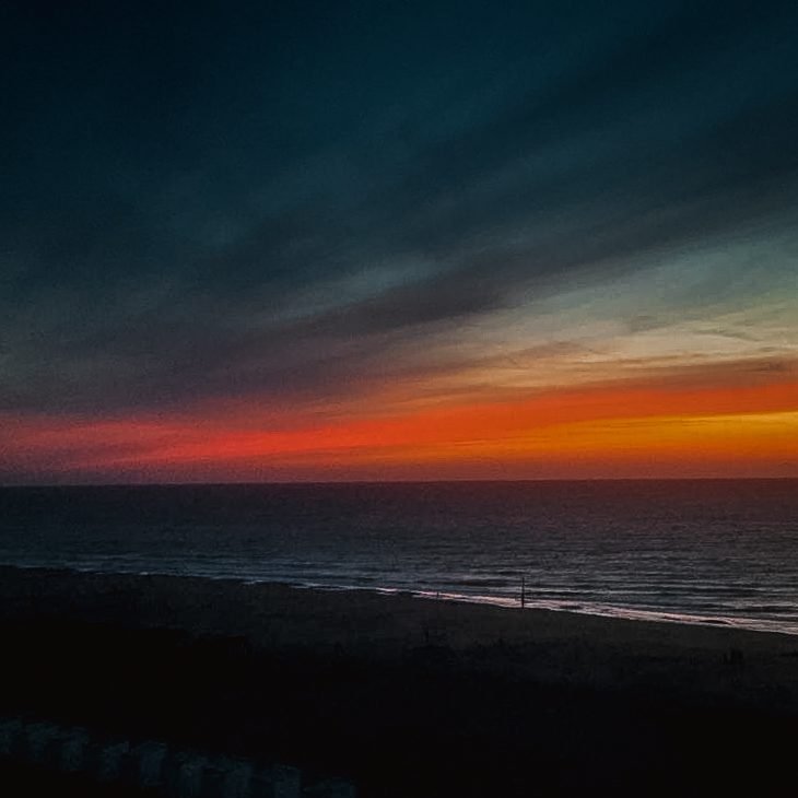 Moody winter sunset over the North Sea at De Panne, when many restaurants close midweek