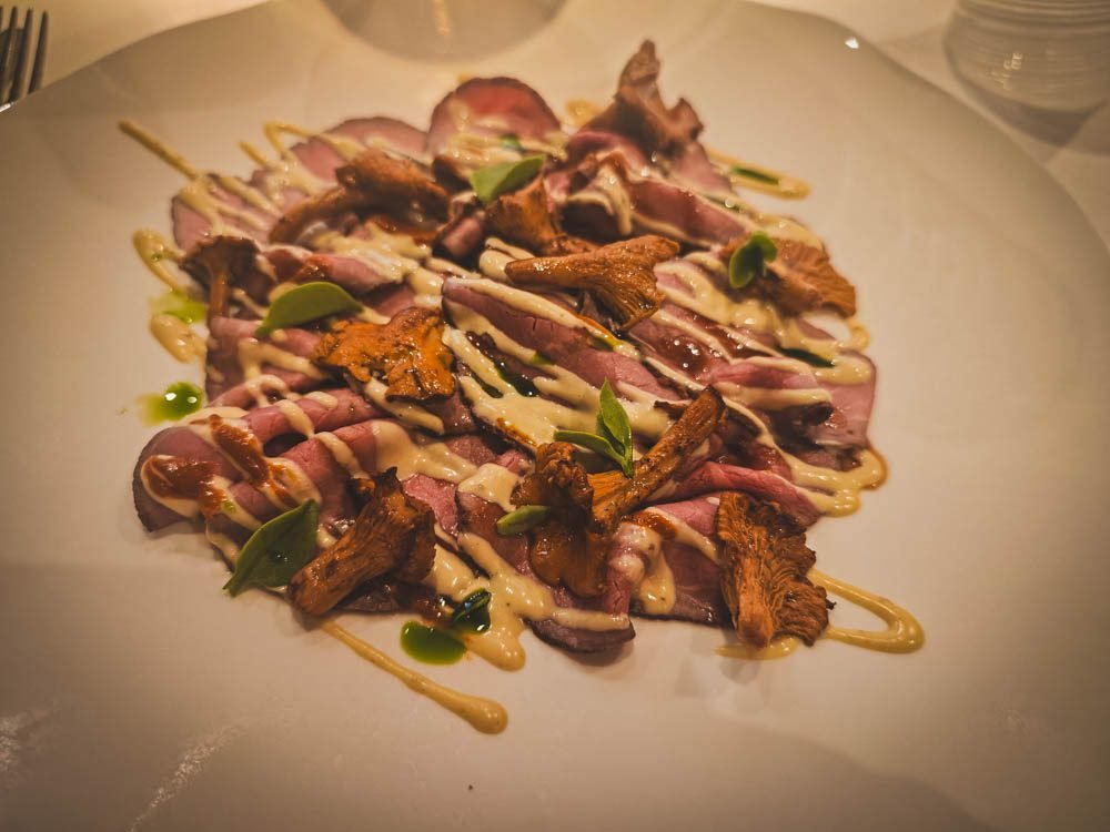 Rosé beef with chanterelles plated at Il Ridotto, a nine-table restaurant near San Marco in Venice