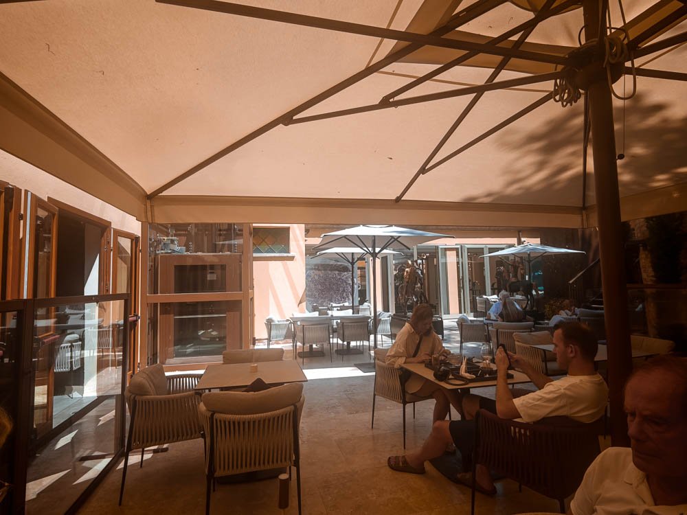 Shaded garden terrace at Marcandole Cafè des Arts, the art gallery restaurant near the Accademia in Venice