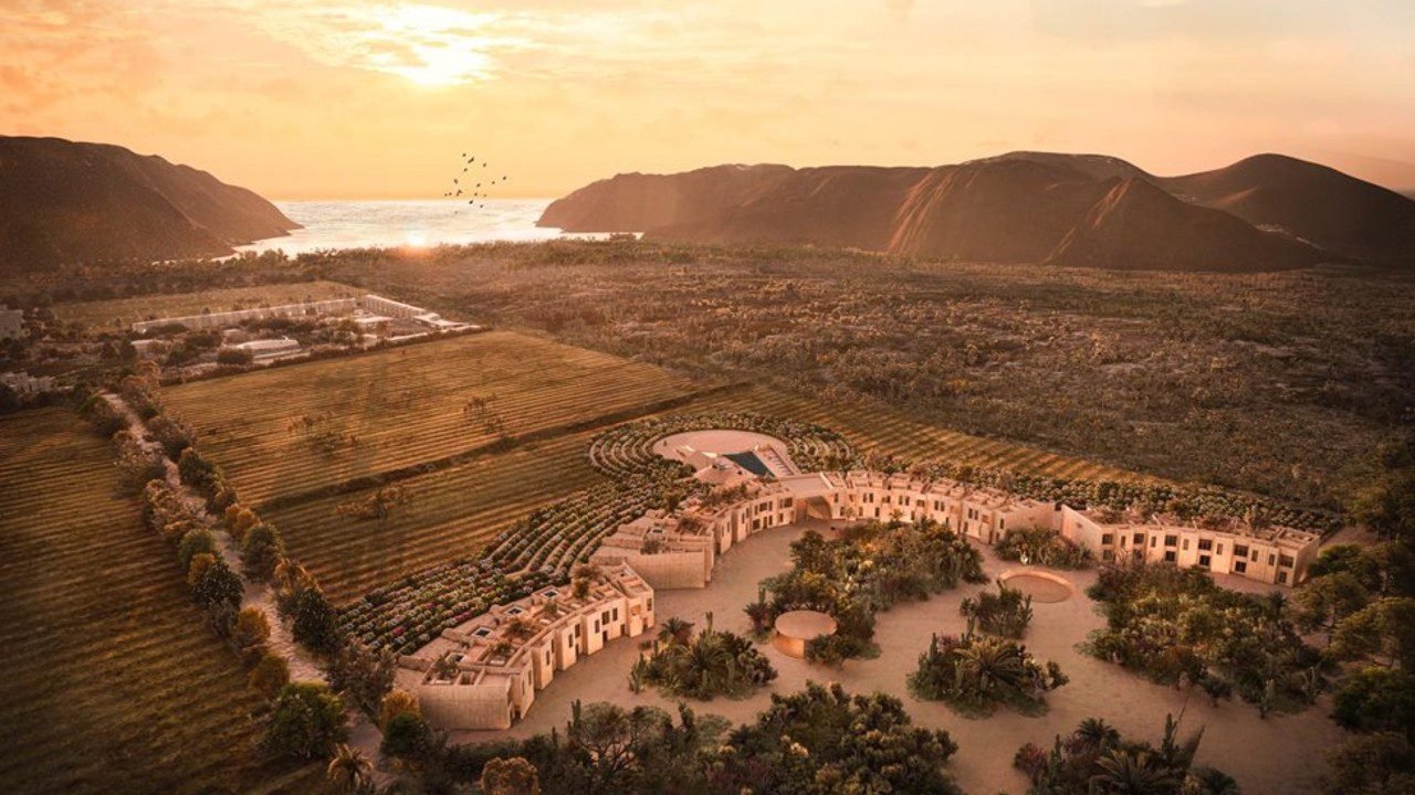 Rendering of the 160-acre Paradero Todos Santos estate at sunset, farmland in the foreground and the Pacific coast beyond