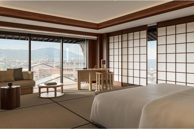 Tatami guest room at Capella Kyoto with shoji screens and a view over the city to the Higashiyama hills