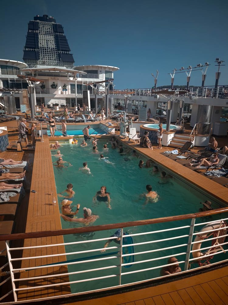 Passengers packed around the main pool on Celebrity Constellation