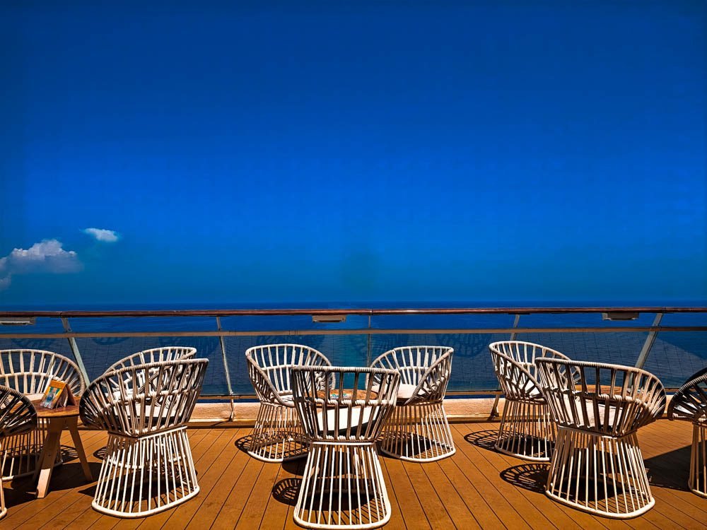 Celebrity Constellation review: teak deck with wicker armchairs on the Resort Deck