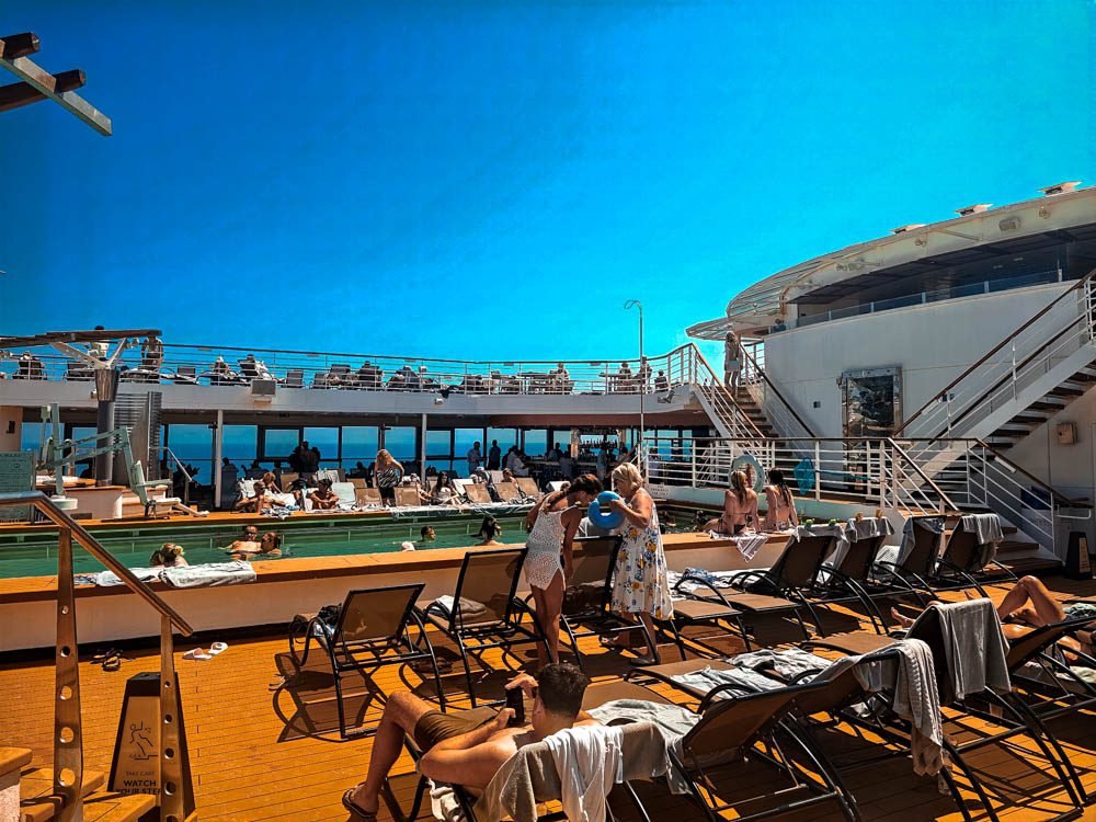 Crowded sun deck and pool on Celebrity Constellation