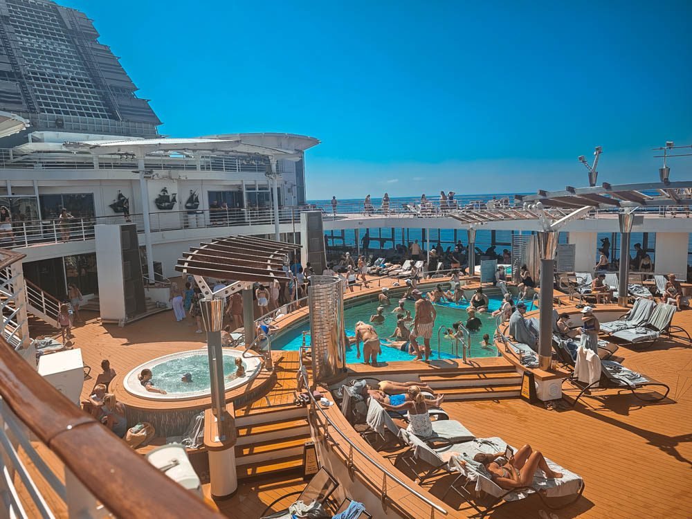 Crowded pool area on a sea day aboard Celebrity Constellation