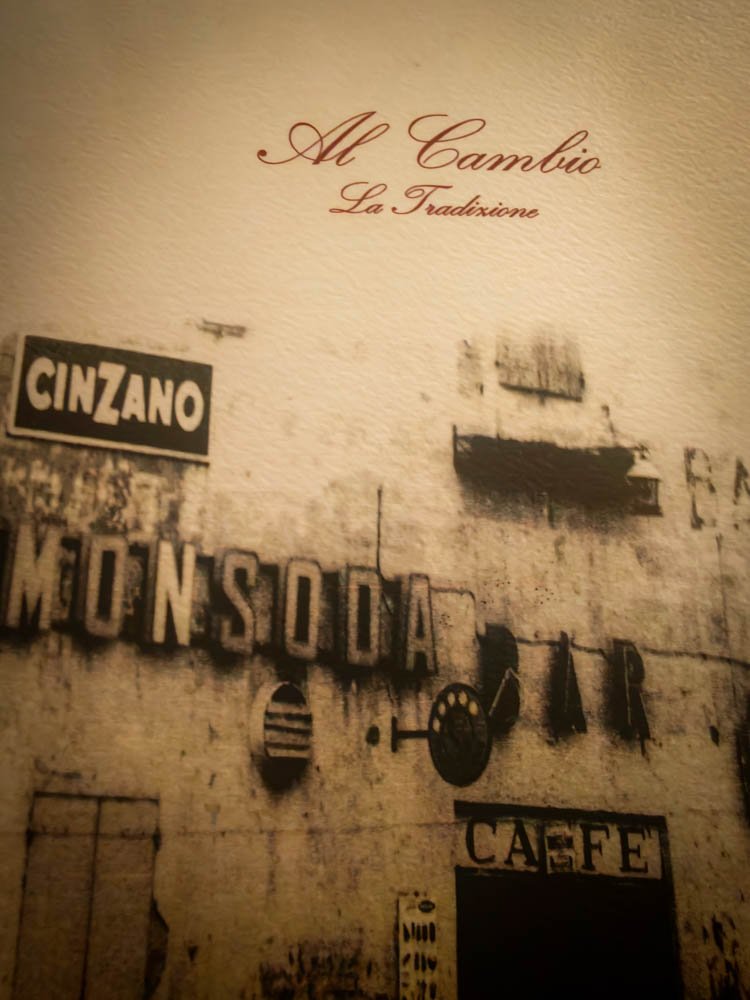 Al Cambio restaurant sign painted on a wall in Bologna, Italy