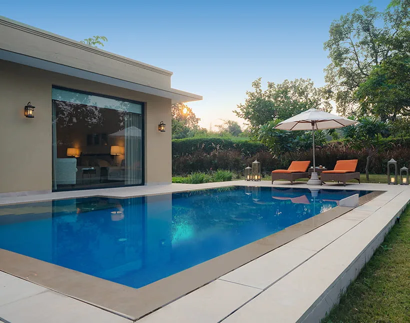 Private pool of a Luxury Villa at dusk at The Oberoi Vindhyavilas Wildlife Resort near Bandhavgarh National Park