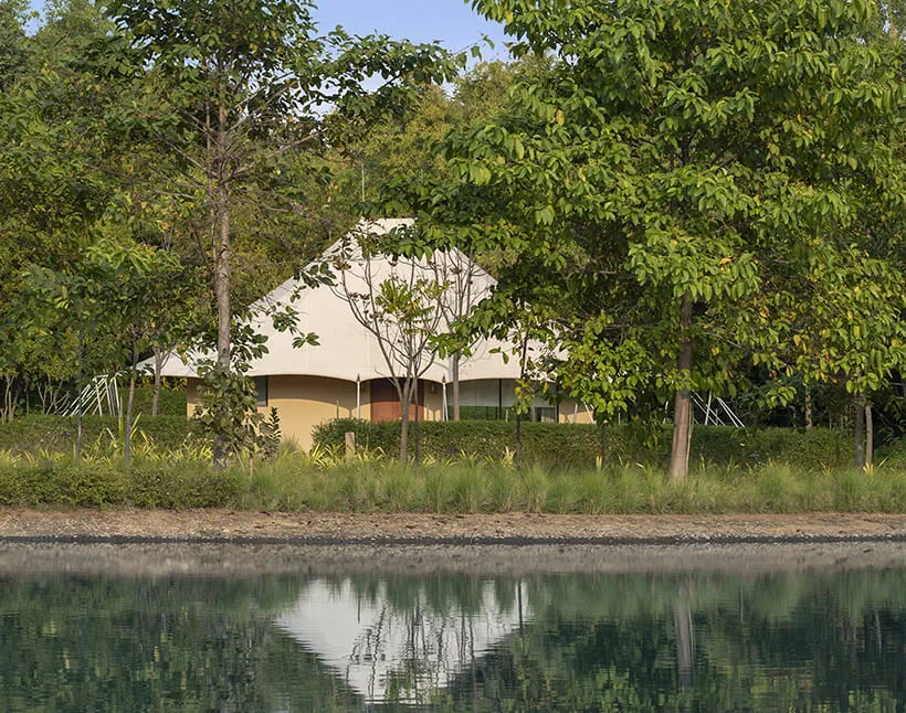 Luxury tent reflected in the lake at The Oberoi Vindhyavilas Wildlife Resort, Bandhavgarh