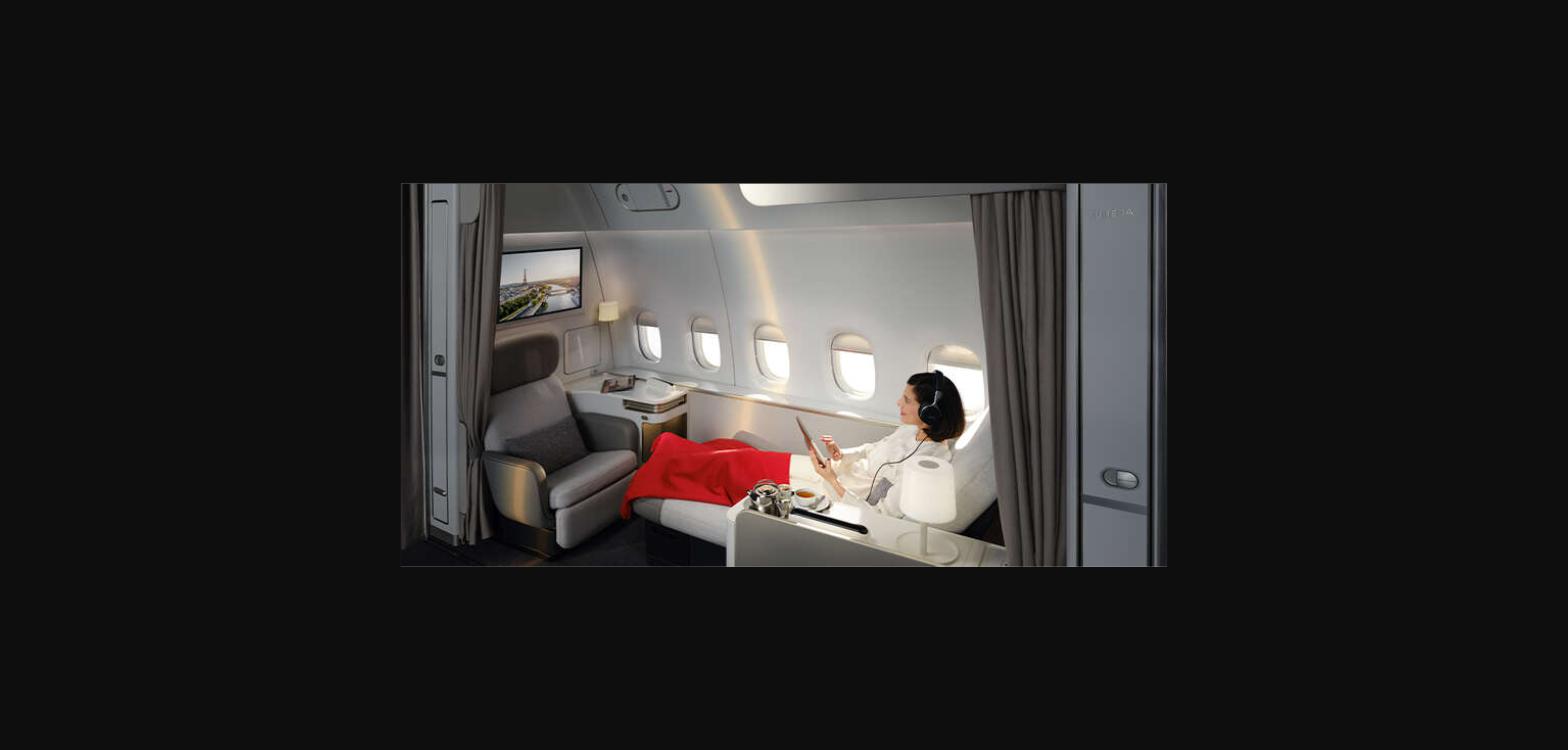 A passenger relaxing on the chaise longue in the new Air France La Première suite