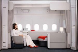 Air France La Première suite on the Boeing 777-300ER, showing the reclining armchair, the separate chaise longue and five windows