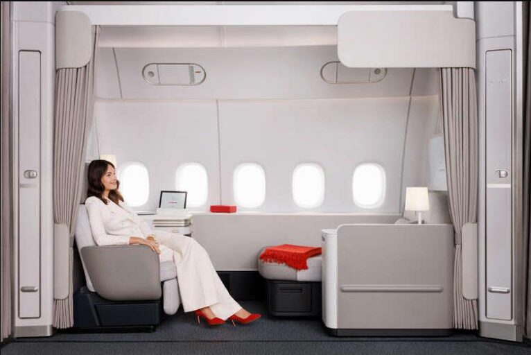 Air France La Première suite on the Boeing 777-300ER, showing the reclining armchair, the separate chaise longue and five windows