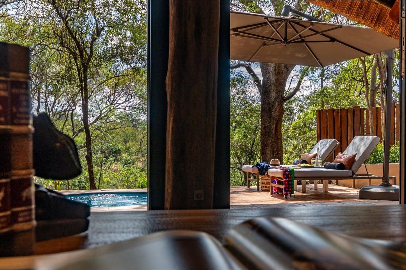 The view from a villa lounge out to the shaded terrace and plunge pool at Albida - Victoria Falls