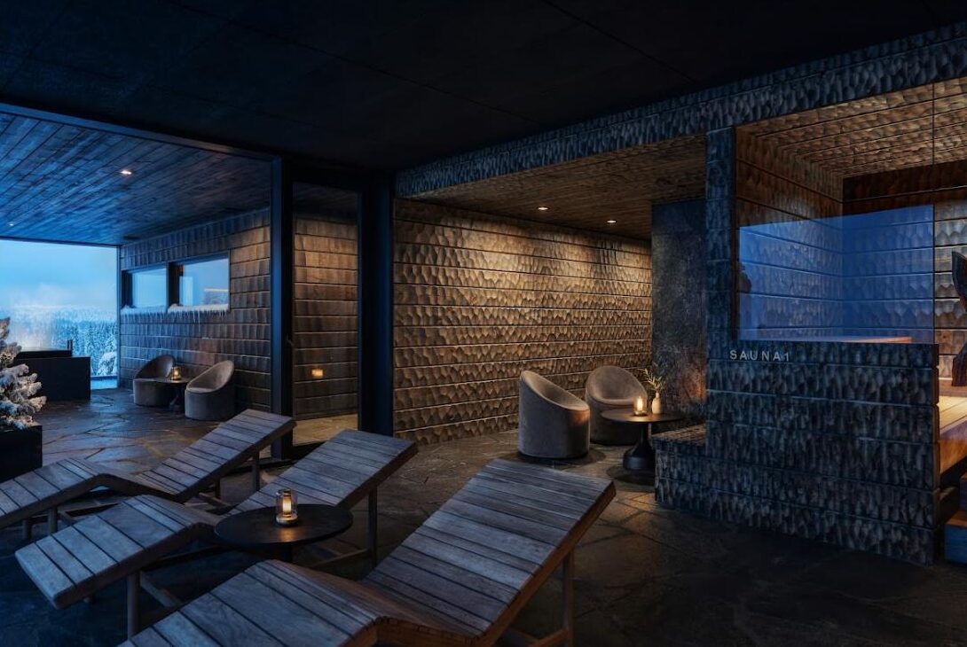 Spa lounge and sauna at Arcora Boutique Hotel & Villas, with loungers facing the snowbound Lapland forest