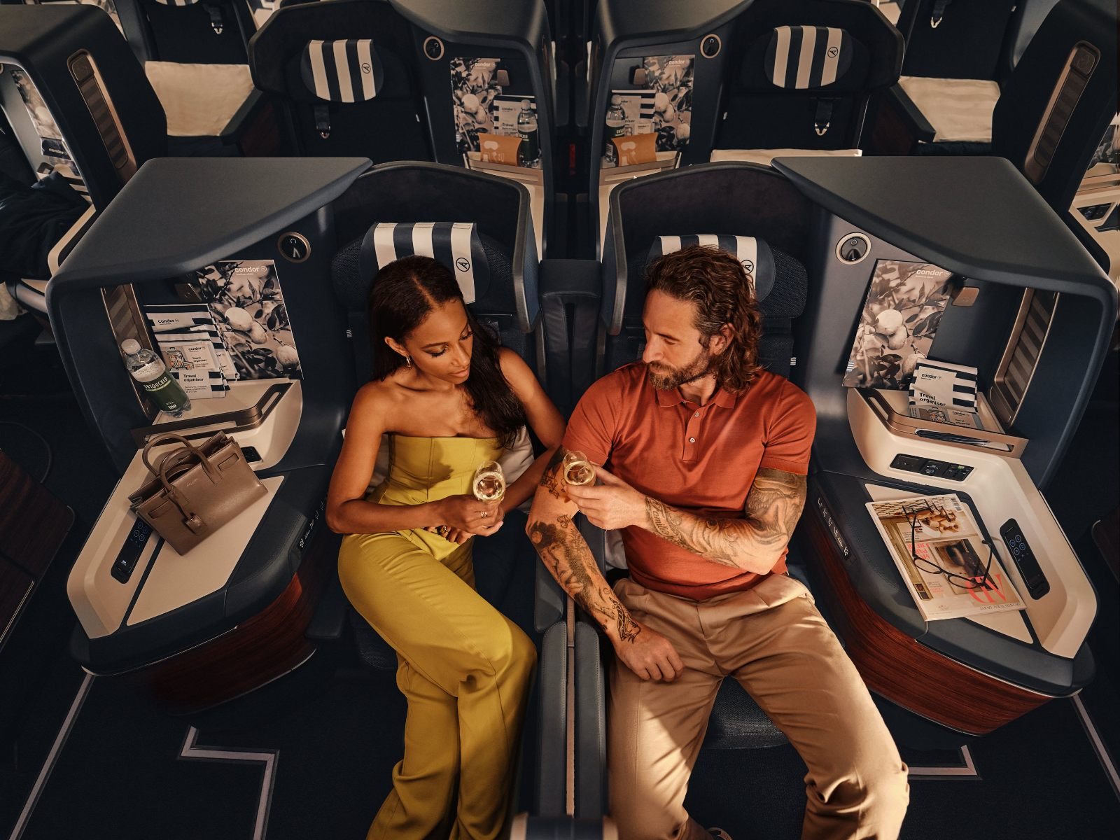 Two passengers talking across the centre pair of Condor A330neo Prime Seats
