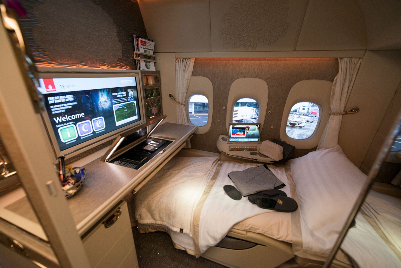 Emirates Boeing 777 First Class suite made up as a flat bed with the entertainment screen on
