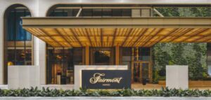 The illuminated entrance canopy and green wall at Fairmont Hanoi, near the Old Quarter