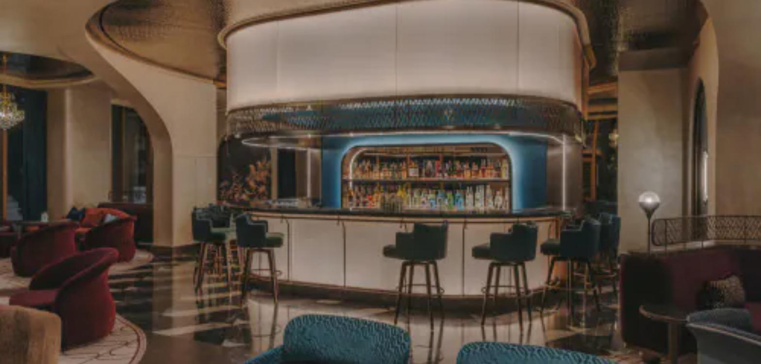 The curved central bar and velvet seating at YY Bar, Fairmont Hanoi