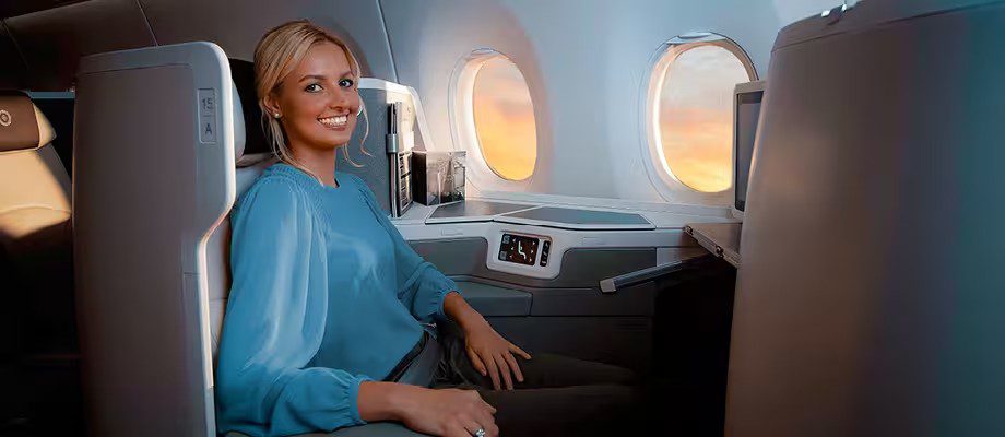 Passenger smiling in a Fiji Airways business class seat on the A350