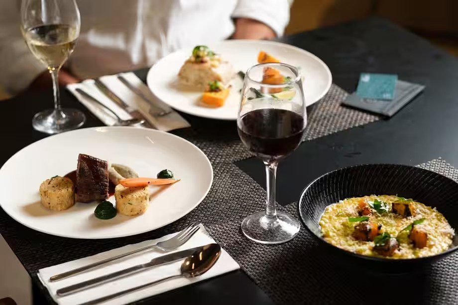 Plated dishes and wine served in the Fiji Airways Premier Lounge at Nadi
