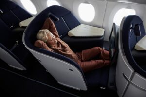 Passenger lounging with her feet up in a Finnair AirLounge business class seat on the A350