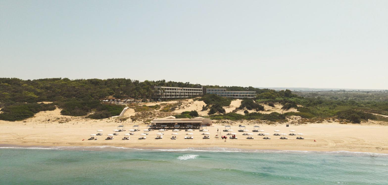 Icona’s Costa Ragusa Resort seen from the sea above its private beach, Sicily