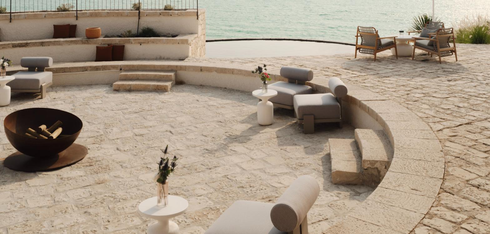 Icona’s Costa Ragusa Resort beach club terrace and fire pit, Sicily