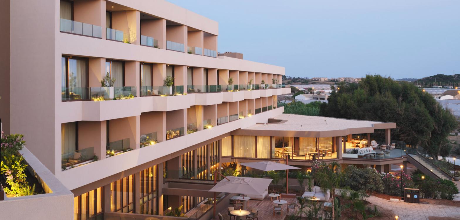Icona’s Costa Ragusa Resort exterior and guest terraces at dusk, Sicily