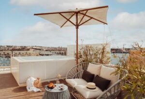 Rooftop terrace of the Vitalis Pool Suite at Iniala Valletta with a plunge pool, parasol and views across Valletta's Grand Harbour
