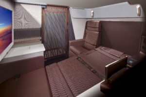 Japan Airlines A350-1000 First Class suite with sliding door, seat in bed mode and large screen
