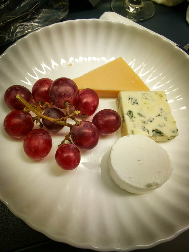 KLM business class cheese plate with Beemster Royal Grand Cru, Moulin Bleu, goat cheese and grapes