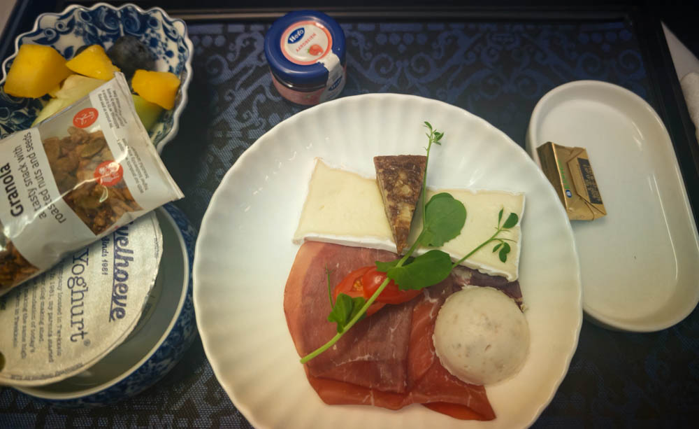 KLM business class breakfast tray with granola, yoghurt, bresaola and brie