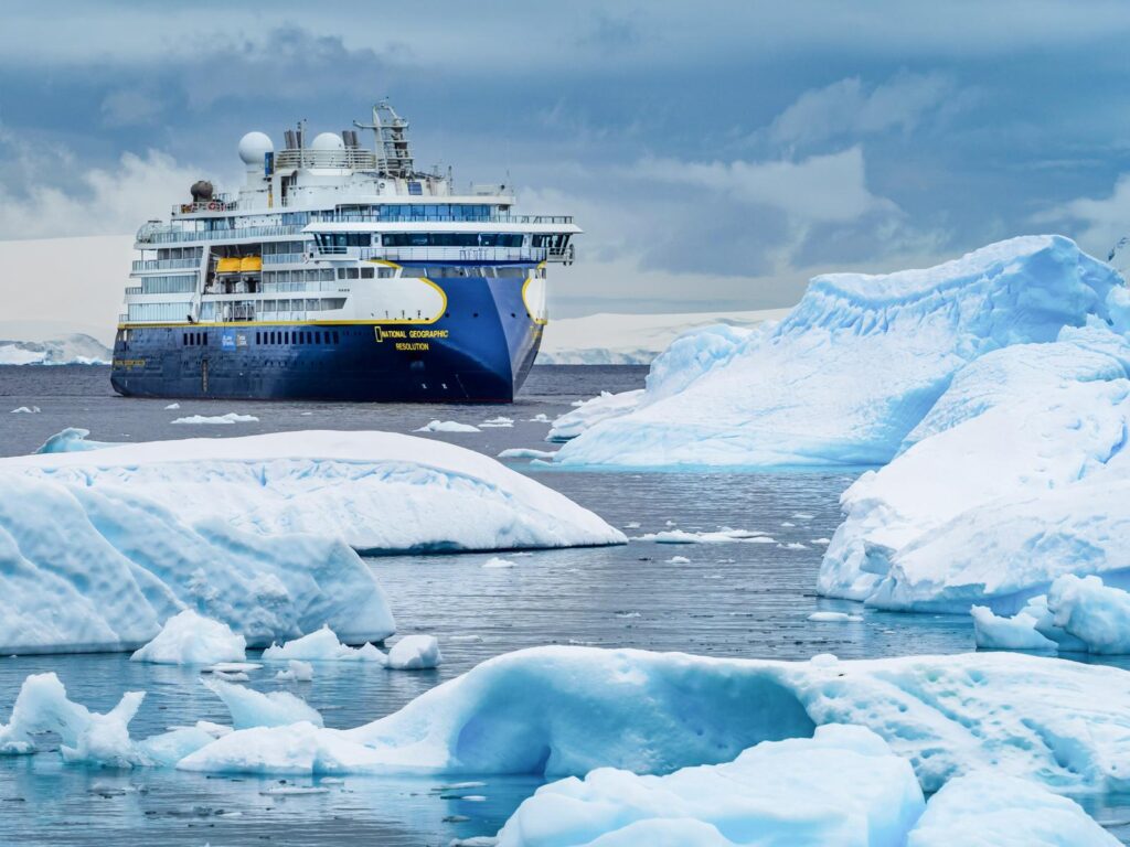 A Lindblad Expeditions ship sailing among icebergs in the Gerlache Strait, Antarctica