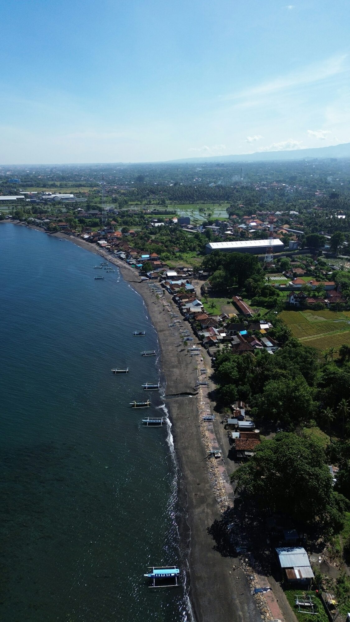 Aerial view of Lovina beach and traditional jukung boats on Bali's north coast
