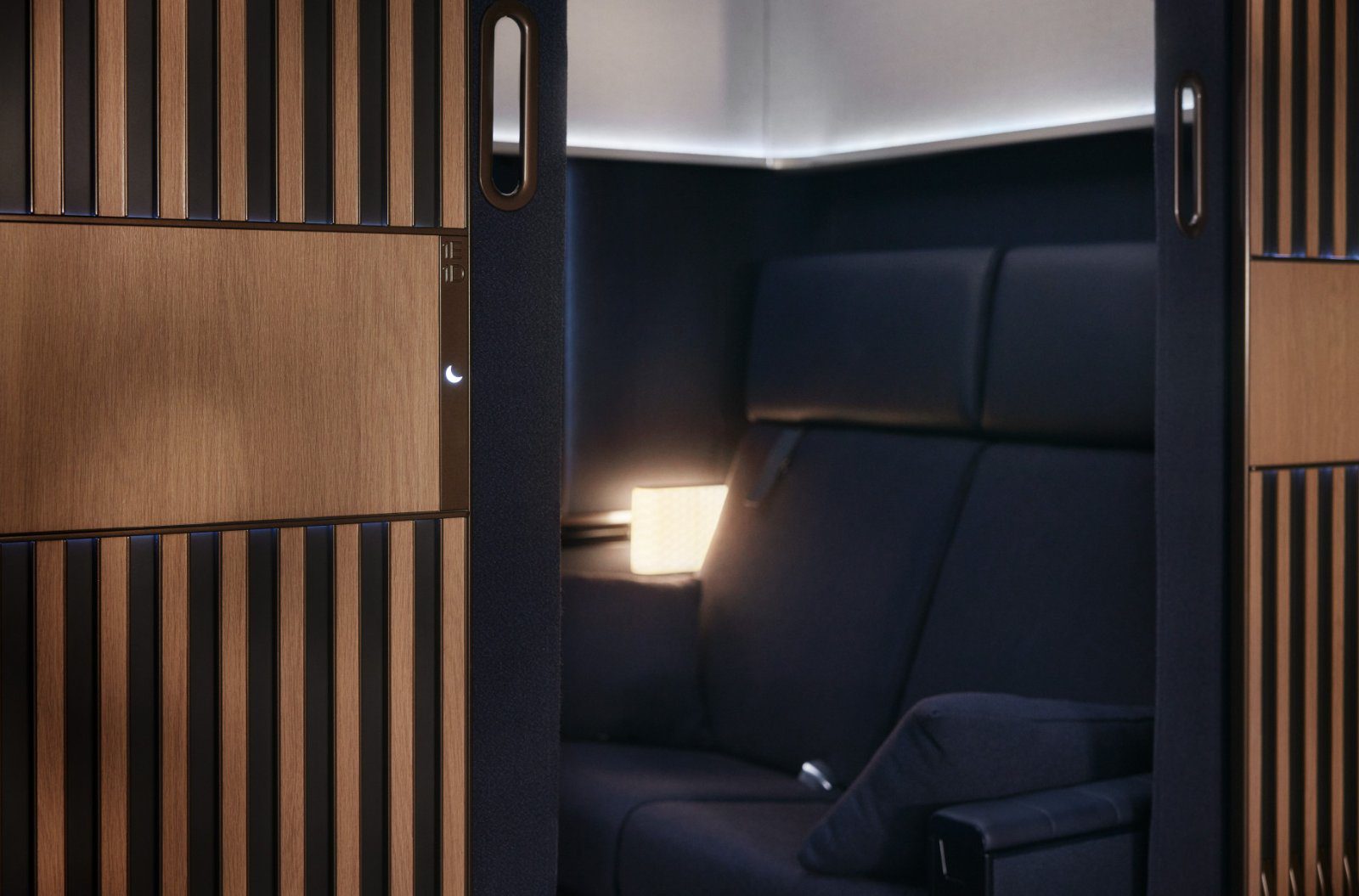 Interior of a Lufthansa Allegris First Class suite with seat, table and screen