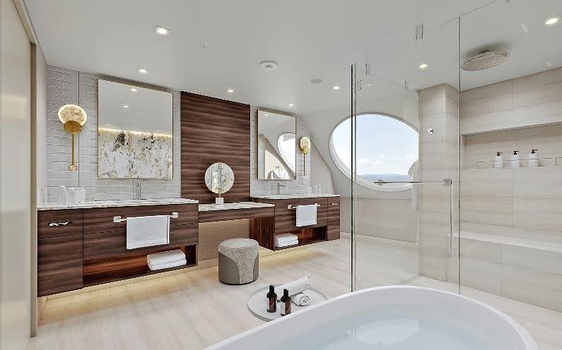 Rendering of an Oceania Suite master bathroom on Oceania Sonata, with twin vanities, a walk-in shower and a round window