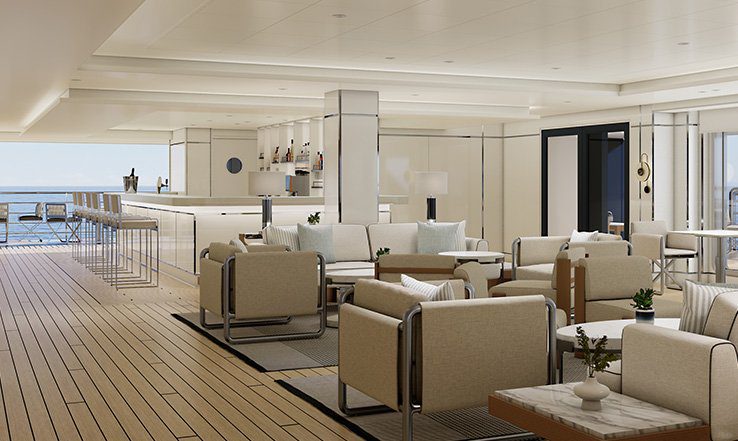 An open-sided deck lounge aboard Luminara with a marble bar, cream armchairs and low tables on teak decking, looking out to the sea