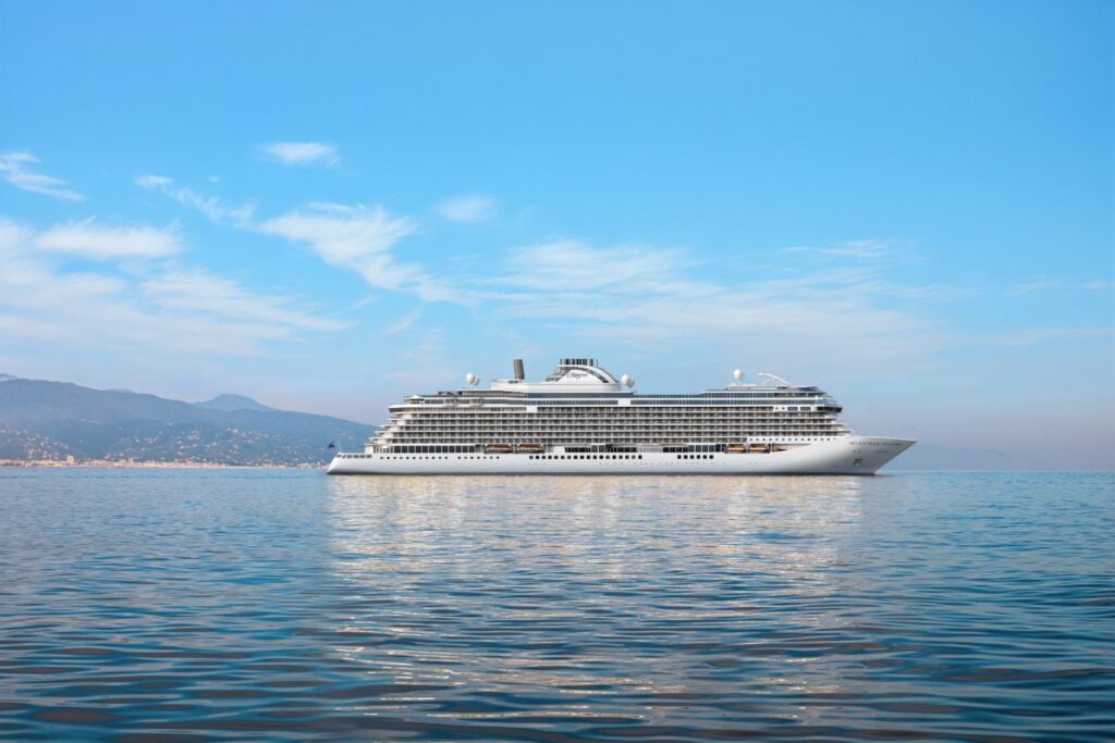 Rendering of Seven Seas Prestige at sea, the new Regent Seven Seas Cruises ship shown off a mountainous coastline