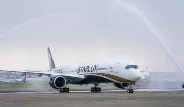 STARLUX first Airbus A350-1000 taxiing through a ceremonial water salute at Taipei Taoyuan