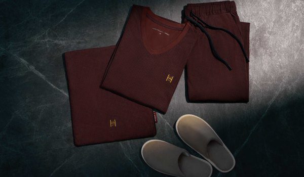 STARLUX First Class loungewear made with Huntsman of Savile Row, folded beside cabin slippers