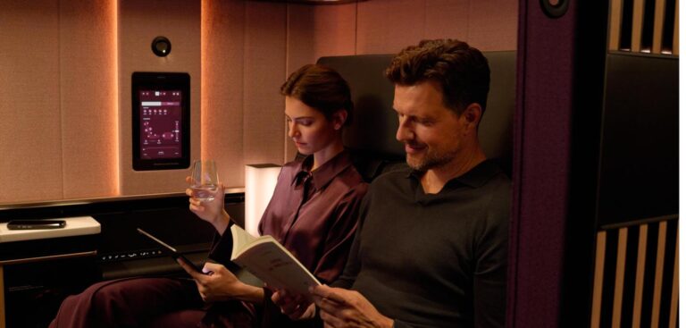 Two passengers sitting together in the SWISS Senses First Class Suite Plus with the sliding door closed