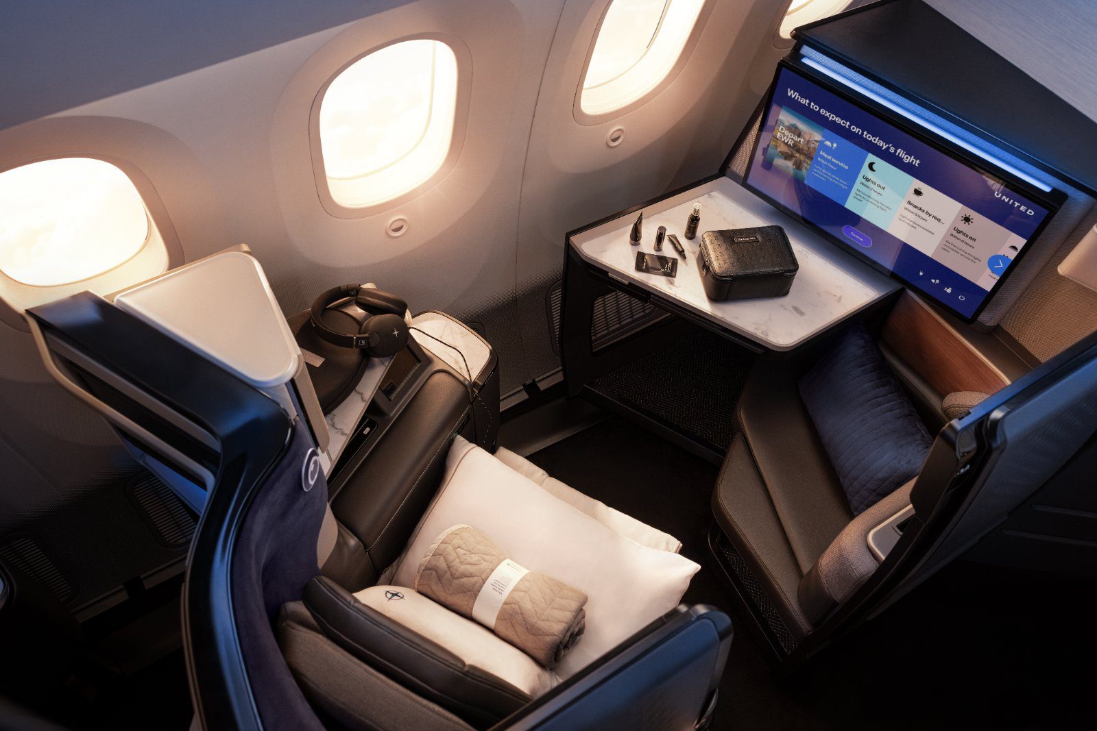 United Polaris Studio suite set for dining with amenities and caviar service