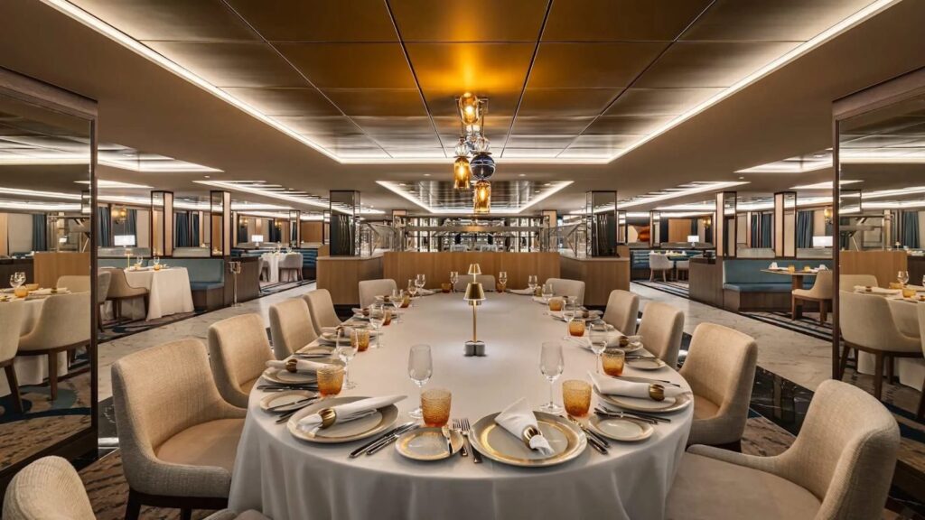 Amphora restaurant on Star Seeker, sister ship to Star Explorer, with a round table set for dinner under a brass chandelier