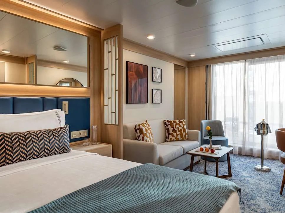 Vista Veranda Suite on Star Seeker, the sister ship Windstar uses to show Star Explorer's suites: bed, sofa and floor-to-ceiling windows