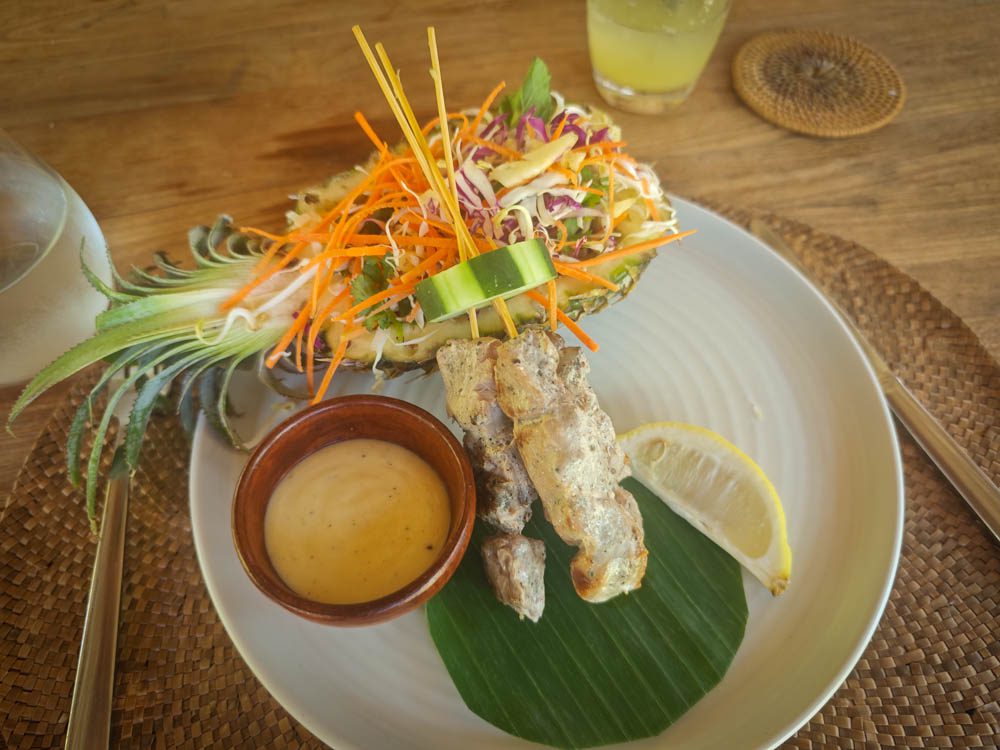 Sate lilit on lemongrass stalks with shredded salad, dipping sauce and lemon at Goddess Retreat Ubud