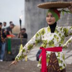 Bandanese dancer balancing a woven tray on her head at Fort Belgica, Banda Neira