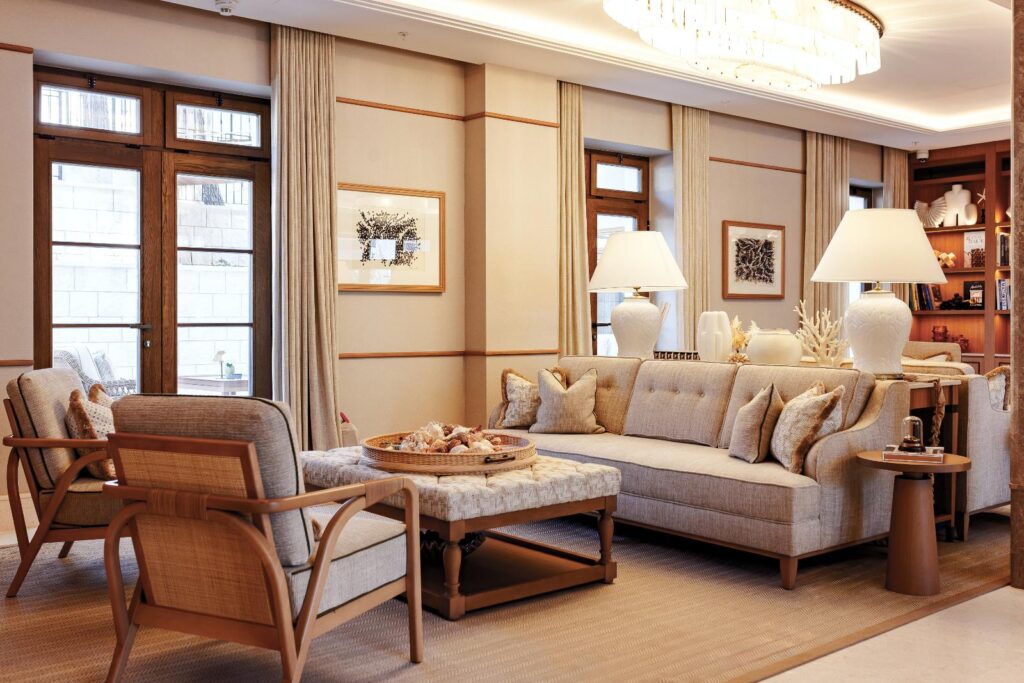 Lobby lounge with limestone walls and linen sofas at The Bristol Bol